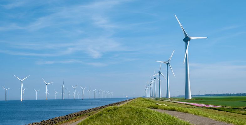 Offshore Windmill farm in the ocean Westermeerwind park, windmills isolated at sea on a beautiful bright day Netherlands Flevoland Noordoostpolder. Huge windmill turbines